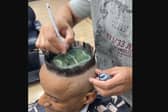 A hair artist created a miniature football stadium on a client's head.