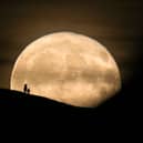 A Beaver Moon rises behind the Grade I listed St Michael's Tower on the top of Glastonbury Tor in 2017.