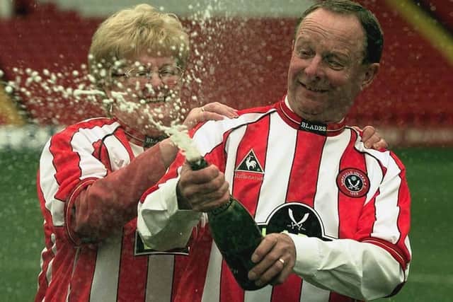 Sheffield United fans Ray and Barbara Wragg celebrate winning a £7,649,520 jackpot from the National Lottery at Bramall Lane football ground on January 25, 2000.