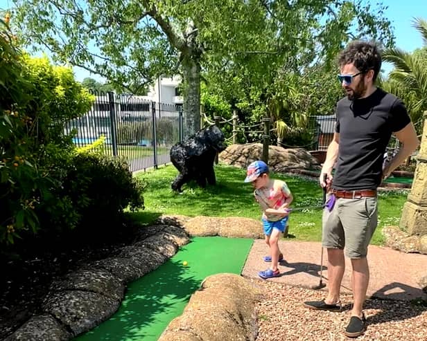 George accidentally hits his dad James between the legs at crazy golf.