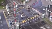 Woman hit by level crossing barrier.