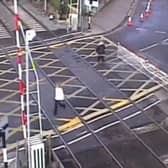 Woman crushed by level crossing barrier.