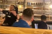 Piper falls off table in pub while entertaining Scotland fans.