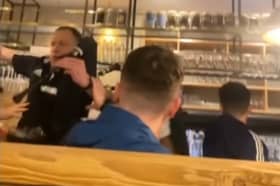 Piper falls off table in pub while entertaining Scotland fans.
