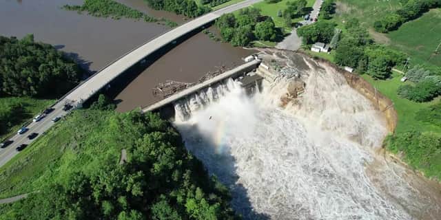 Building swept into Blue Earth River as Rapidan Dam suffers partial failure.