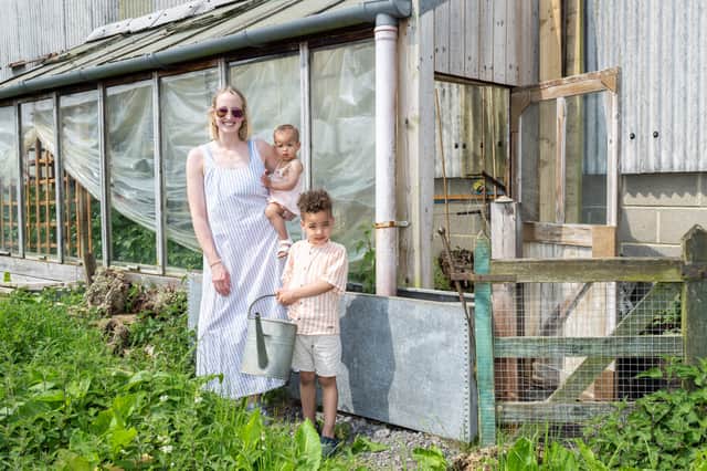Adele Farah who uses rain water collected via her greenhouse roof and is stored in a tank to water her plants and vegetables 