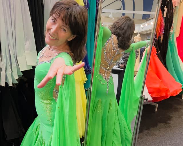 Linda Adams, 64, tries on a dress from Chrisanne Clover Boutique at Blackpool Dance Festival.