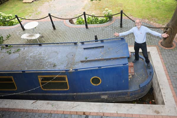 Stephen Cuddy with the mini canal lock he built to house a narrowboat turned into a swimming pool.