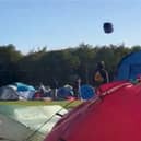 Tent hurtles across sky as Storm Lilian hits Leeds Festival.