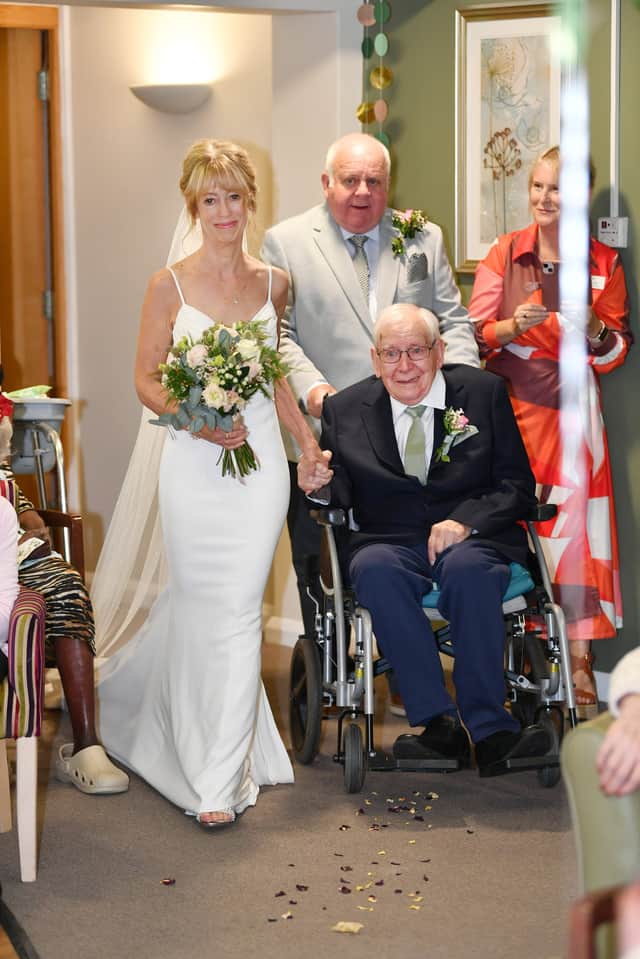 Henry Clayton, 99, escorts his daughter Fiona down the aisle.