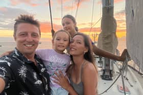 Dan Monk, his wife Bow, and their children Amelia and Olivia sailing on their yacht, Pancakes.