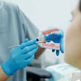 A dentist shows a patient how braces would look on the teeth. (Photo: Pexels/Cedric Fauntleroy)