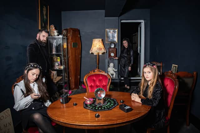 JP Kennedy and Kymmi Jeffery with daughters Snow and Pebble, known as The Occult Family, stood inside their haunted room.