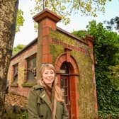 Loz Samuels pictured outside the world's smallest theatre - a former public loo in Malvern, UK.