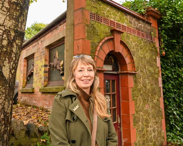 Loz Samuels pictured outside the world's smallest theatre - a former public loo in Malvern, UK.