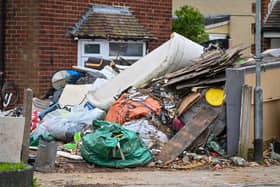 Horrified residents are demanding action after their neighbours turned their home into a makeshift TIP with tonnes of rubbish dumped on the driveway.  