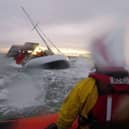 Dramatic footage shows the terrifying moment huge waves crashed into a yacht- seconds before rescue. 