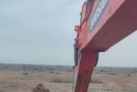 Video grab as a camel was rescued from being stuck in mud in the middle of a desert using an excavator.