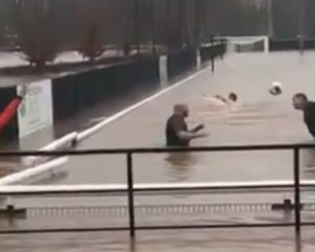 Lydney Town AFC players go swimming on their pitch.