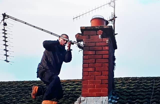 Dennis Iliffe's aerial being fixed following Storm Darragh.