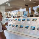 Tourists look at apartments in the window shop of a real estate on the island of Ibiza (Photo: JAIME REINA/AFP via Getty Images)