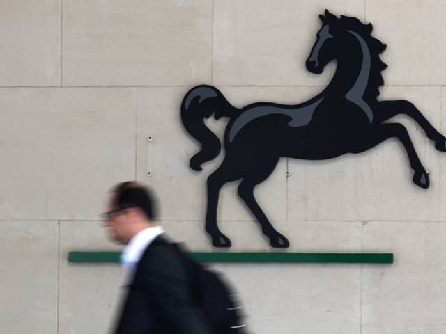 A man passes the entrance to a Lloyds Banking Group office in the City of London (Photo: JUSTIN TALLIS/AFP via Getty Images)