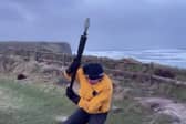 Video taken by the weather tracking group shows their team member battling against the strong winds while attempting to measure the wind speed. 