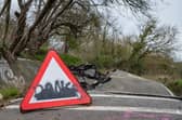 A road left so badly damaged by a landslip it was closed to cars can't be fixed properly - as it's still moving a YEAR later.  