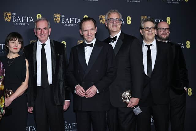 Juliette Howell, Robert Harris, Ralph Fiennes, Michael Jackman and Nick Emerson pos with the Outstanding British Film Award for 'Conclave' during the 2025 BAFTAs
