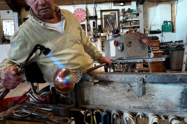 John Ditchfield, master glass maker crafting a beautiful colourful sculpture
