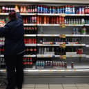 An employee stocks shelves at a Tesco supermarket in central London in 2021 (Photo: JUSTIN TALLIS/AFP via Getty Images)