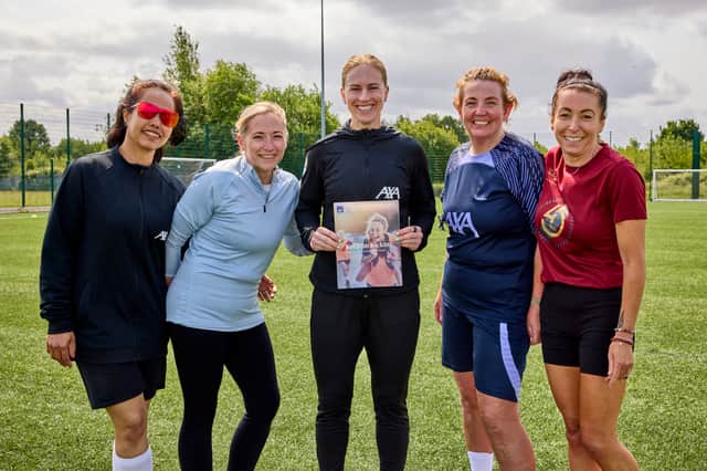 Tash Dowie and players from the Liverpool WWF team with the  report which highlights female challenges in sport