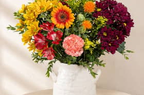 Bunches’ Autumn Sunrise bouquet combines warm yellow, orange, red and burgundy blooms for a colourful seasonal display.