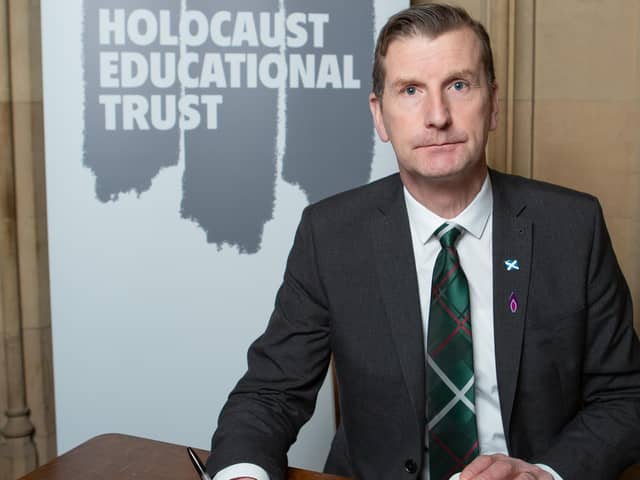 ​Dave Doogan signs the Book of Commitment at the House of Commons.