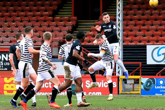 Graham Webster with a header on goal during the weekend's win. Pic by Phoenix Photography