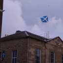 The Saltire flies at half-mast over Town and County Hall in Forfar.