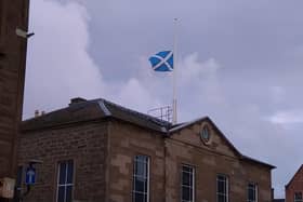 The Saltire flies at half-mast over Town and County Hall in Forfar.