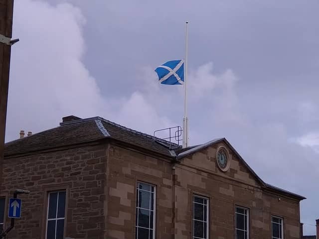 The Saltire flies at half-mast over Town and County Hall in Forfar.