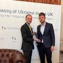 ​Mr Gethins presents the Angus Council tie at the Ukraine embassy.
