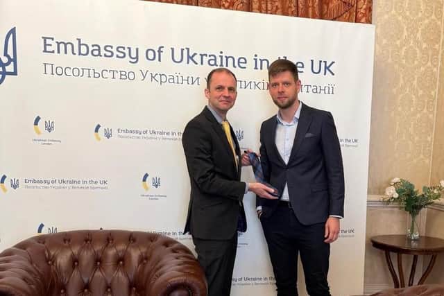 ​Mr Gethins presents the Angus Council tie at the Ukraine embassy.