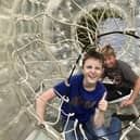 Two of NESS’s Young People's Sensory Service members enjoy playing in a zorbing ‘bubble tunnel’.