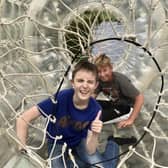 Two of NESS’s Young People's Sensory Service members enjoy playing in a zorbing ‘bubble tunnel’.