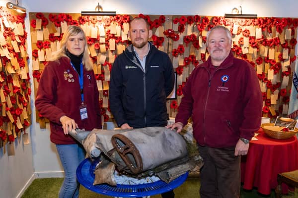 ​Neil White is pictured handing the aircraft part over to Sian Brewis, (left) and Stuart Archibald, Montrose Air Station Heritage Centre chairman. (Pic: Jamie Dryden)