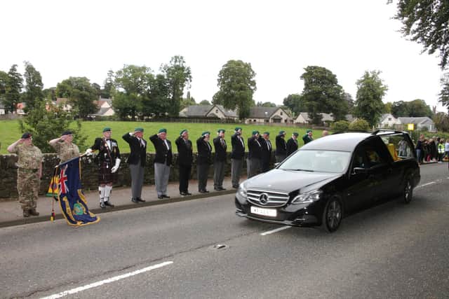 Former serving Royal Marines, and cadets, salute the cortege at Brechin.