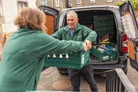 Foodbank volunteers unload food bank donations. Credit: Chris Lacey Photography