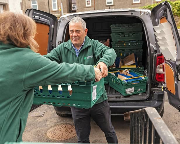 Foodbank volunteers unload food bank donations. Credit: Chris Lacey Photography