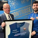 Chairman John Crawford presents Andrew Steeves with his commemorative signed, framed shirt