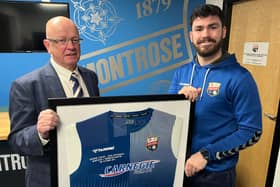 Chairman John Crawford presents Andrew Steeves with his commemorative signed, framed shirt