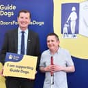 Angus MP Dave Doogan with guide dog owner Philip at the event.