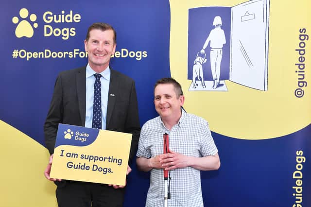 Angus MP Dave Doogan with guide dog owner Philip at the event.